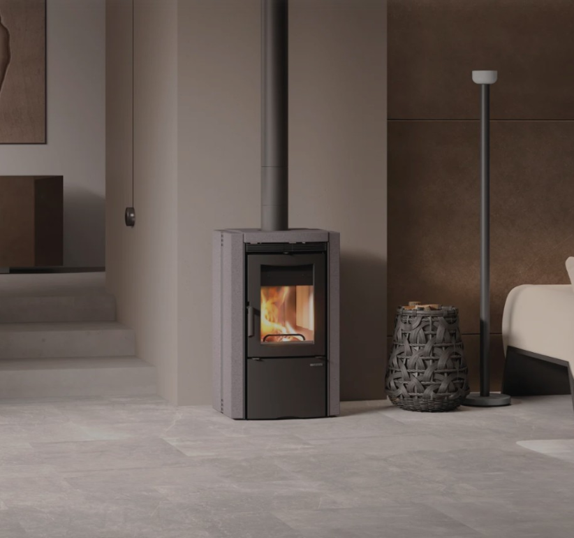 Modern living room with a wood-burning stove, sofa, and decorative elements.