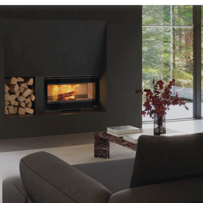 Modern living room with a fireplace, books, and a vase with flowers.