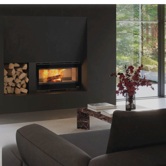 Modern living room with a fireplace, books, and a vase with flowers.