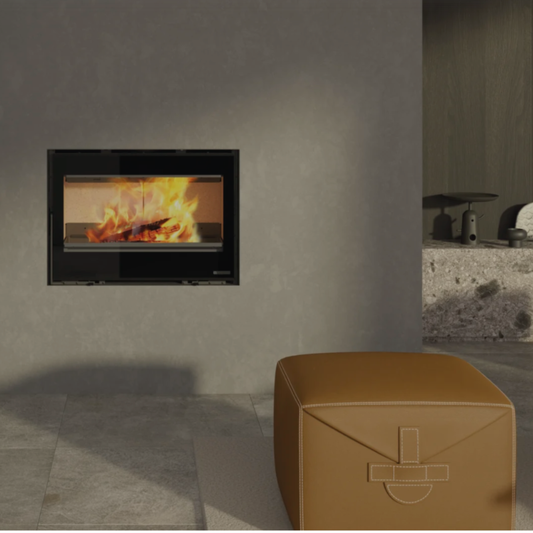 Modern fireplace with flames on a gray wall, next to a brown cube-shaped ottoman.
