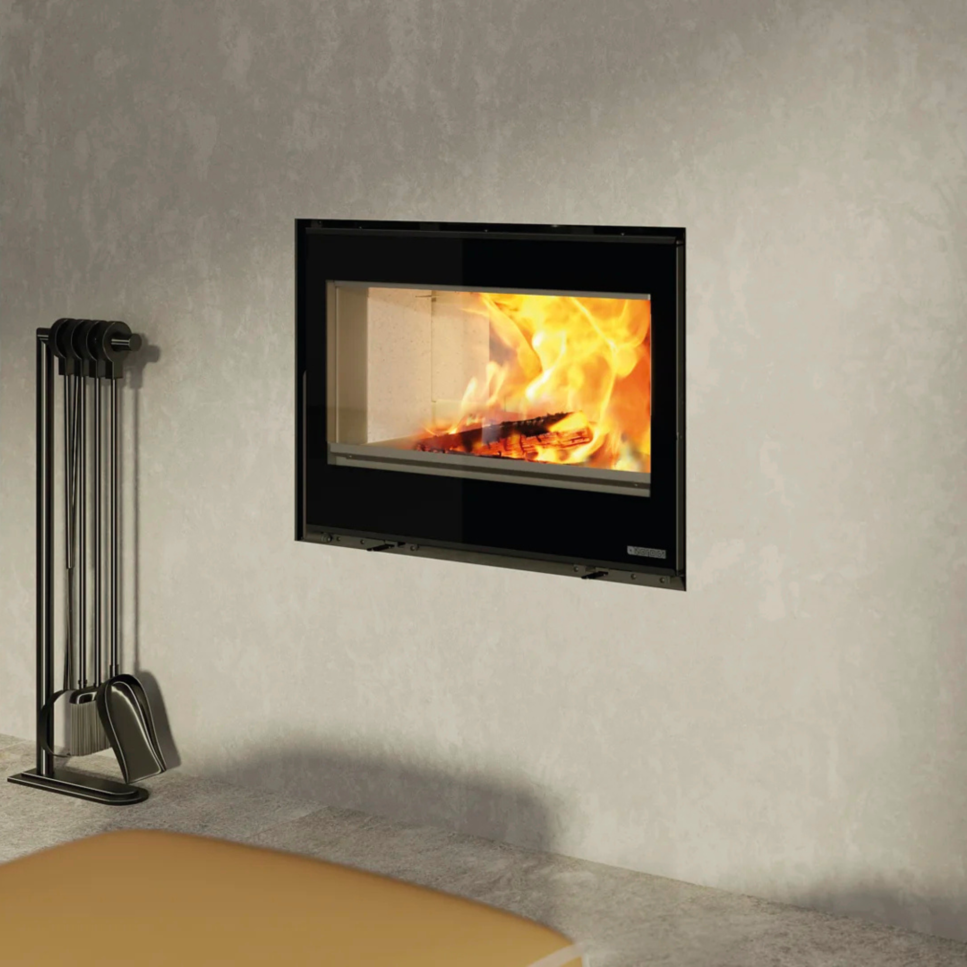 Wall-mounted fireplace with burning logs and a set of metal tools on a gray wall.