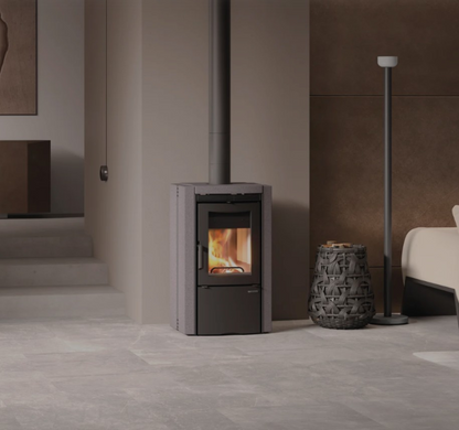 Modern living room with a wood-burning stove, sofa, and decorative elements.