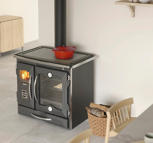 Wood stove with a red pot on top in a room with a chair and basket.